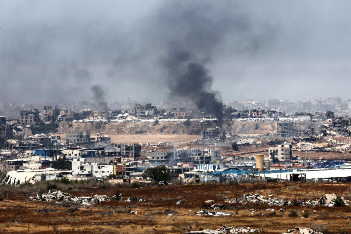  This picture taken from a position in southern Israel on the border with the Gaza Strip shows smoke billowing over destroyed buildings on the Gaza Strip during Israeli bombardment on May 17, 2025. The Israeli military announced the early stages of an intensified operation in Gaza aimed at defeating Hamas, with rescuers in the beseiged Palestinian territory reporting 10 killed on May 17 in fresh Israeli strikes. 