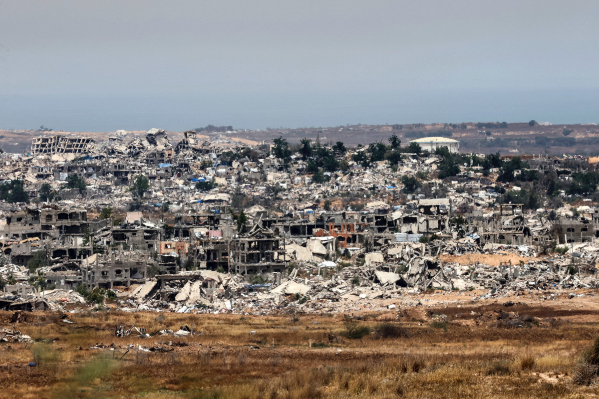  This picture taken from a position in southern Israel shows destroyed buildings in the Gaza Strip on May 17, 2025. The Israeli military announced the early stages of an intensified operation in Gaza aimed at defeating Hamas, with rescuers in the beseiged Palestinian territory reporting 10 killed on May 17 in fresh Israeli strikes. (Photo by Jack GUEZ / AFP)