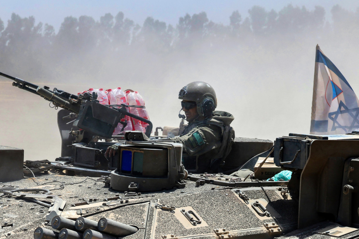  An Israeli soldier rides in a military vehicle at Israel's southern border with the Gaza Strip on May 20, 2025 amid the ongoing war with the Palestinian militant movement Hamas. 