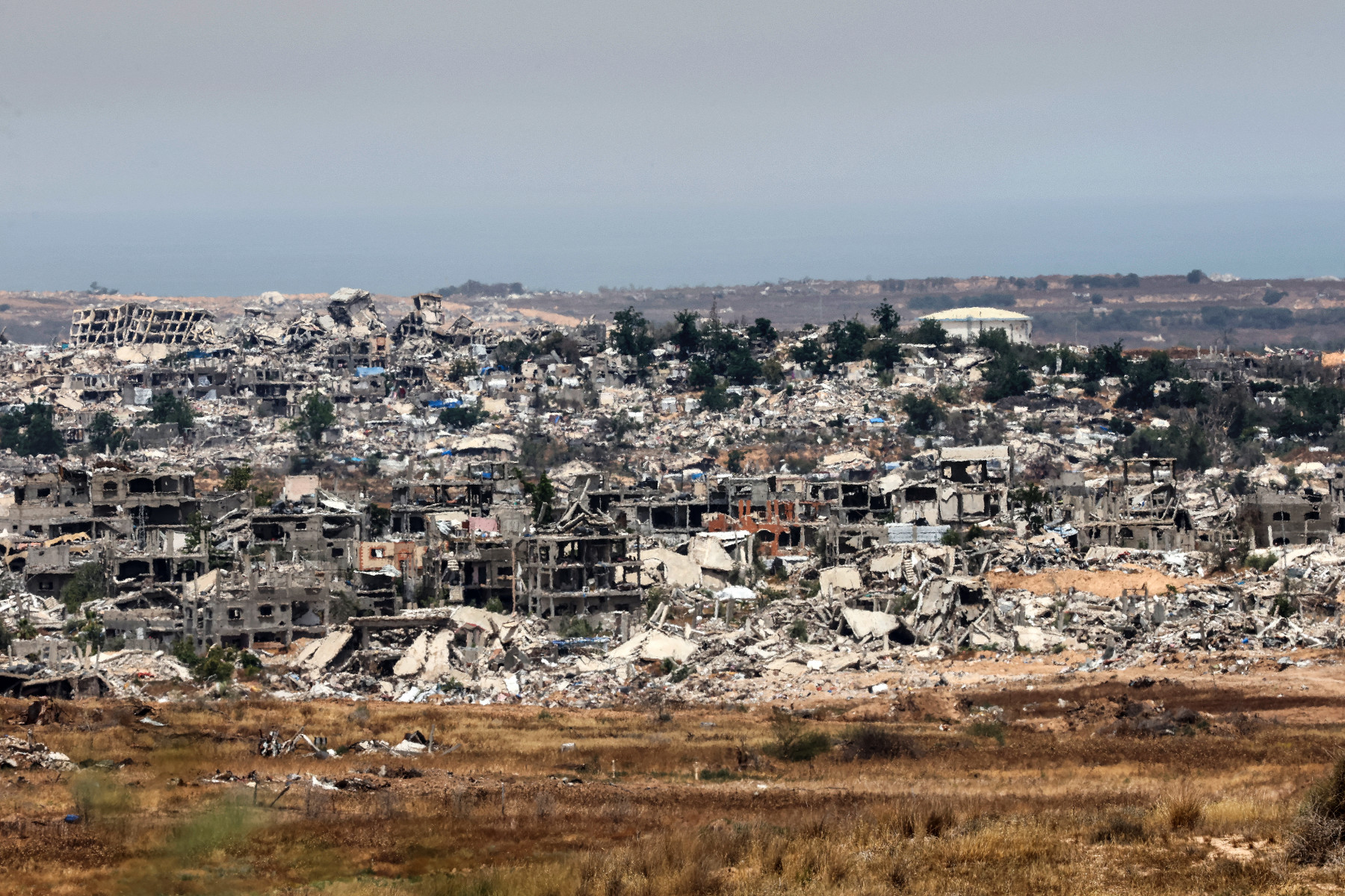  This picture taken from a position in southern Israel shows destroyed buildings in the Gaza Strip on May 17, 2025. The Israeli military announced the early stages of an intensified operation in Gaza aimed at defeating Hamas, with rescuers in the beseiged Palestinian territory reporting 10 killed on May 17 in fresh Israeli strikes. (Photo by Jack GUEZ / AFP)