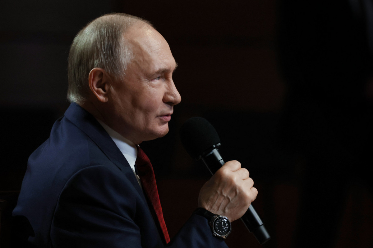  In this pool photograph distributed by the Russian state agency Sputnik, Russian President Vladimir Putin talks with students at the Sirius Educational Center in Sochi on May 19, 2025, after a telephone conversation with US President Donald Trump. 