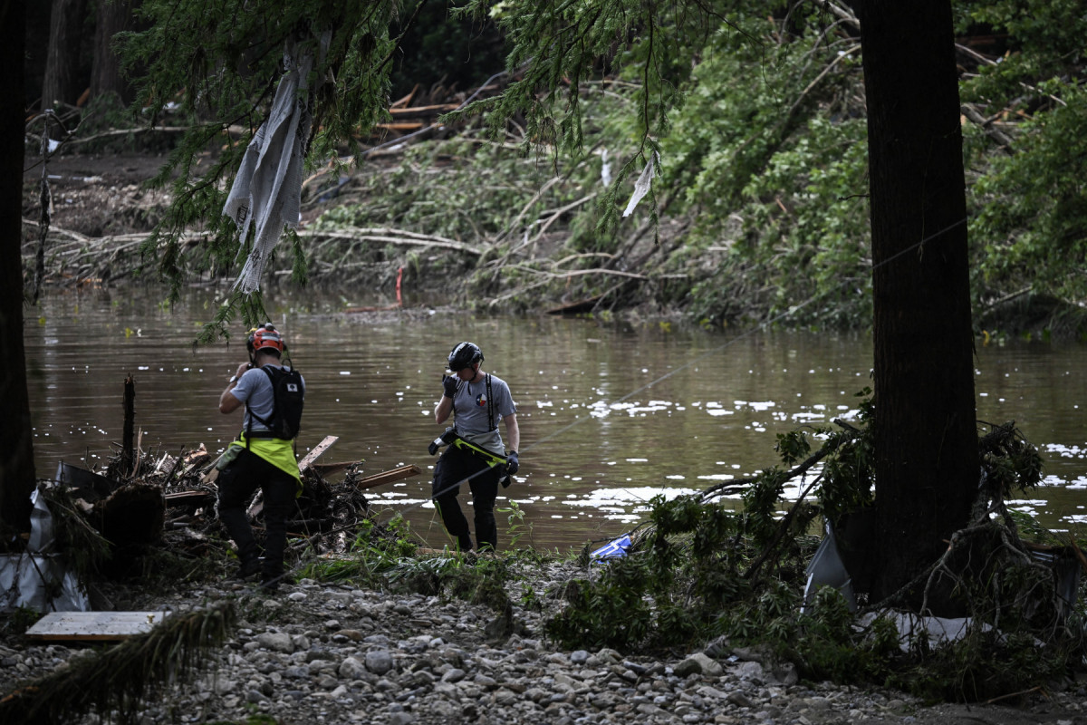 Members of a search and rescue team look for people near Camp Mystic, the site of where at least 20 girls went missing after flash flooding in Hunt, Texas, on July 5, 2025. Rescuers were on Saturday searching for more than 20 girls missing from a riverside summer camp in the US state of Texas, after torrential rains caused devastating flooding that killed at least 27 people -- with more rain on the way. Members of a search and rescue team look for people near Camp Mystic, the site of where at least 20 girls went missing after flash flooding in Hunt, Texas, on July 5, 2025. Rescuers were on Saturday searching for more than 20 girls missing from a riverside summer camp in the US state of Texas, after torrential rains caused devastating flooding that killed at least 27 people -- with more rain on the way.