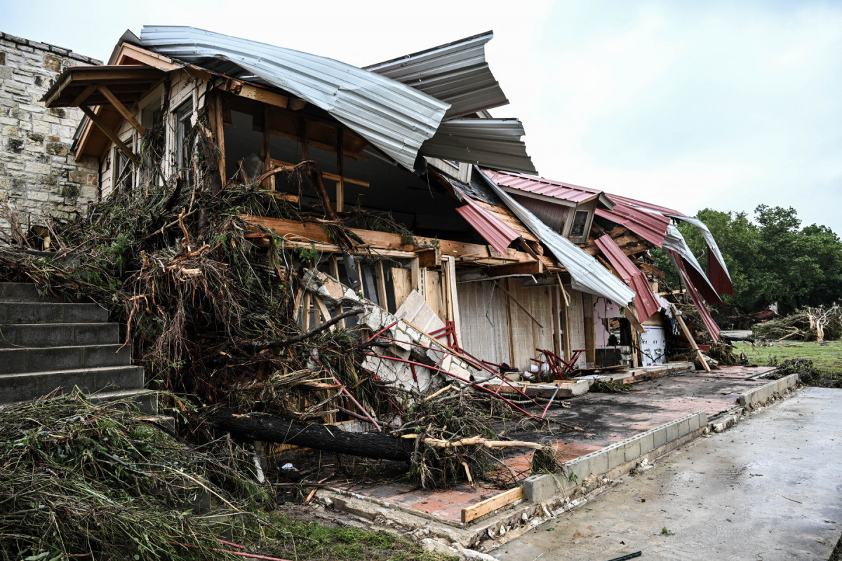  A damaged home is seen near Camp Mystic, the site of where at least 20 girls went missing after flash flooding in Hunt, Texas, on July 5, 2025. Rescuers were on Saturday searching for more than 20 girls missing from a riverside summer camp in the US state of Texas, after torrential rains caused devastating flooding that killed at least 27 people -- with more rain on the way. 