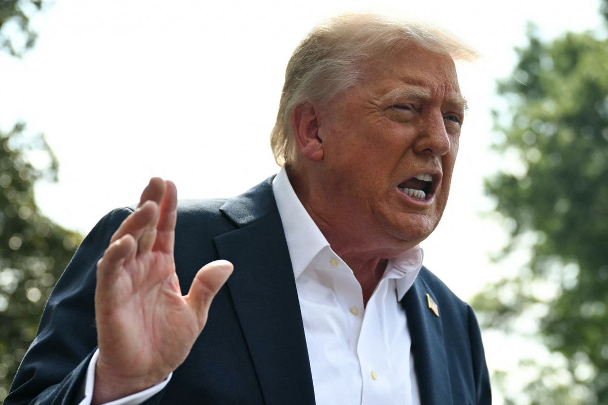  US President Donald Trump speaks to the press before boarding Marine One on the South Lawn of the White House in Washington, DC, on July 11, 2025. Trump is headed to Texas to tour the areas devastated by flash flooding over the Fourth of July weekend which left at least 120 people dead and 170 still missing. (Photo by ANDREW CABALLERO-REYNOLDS / AFP)