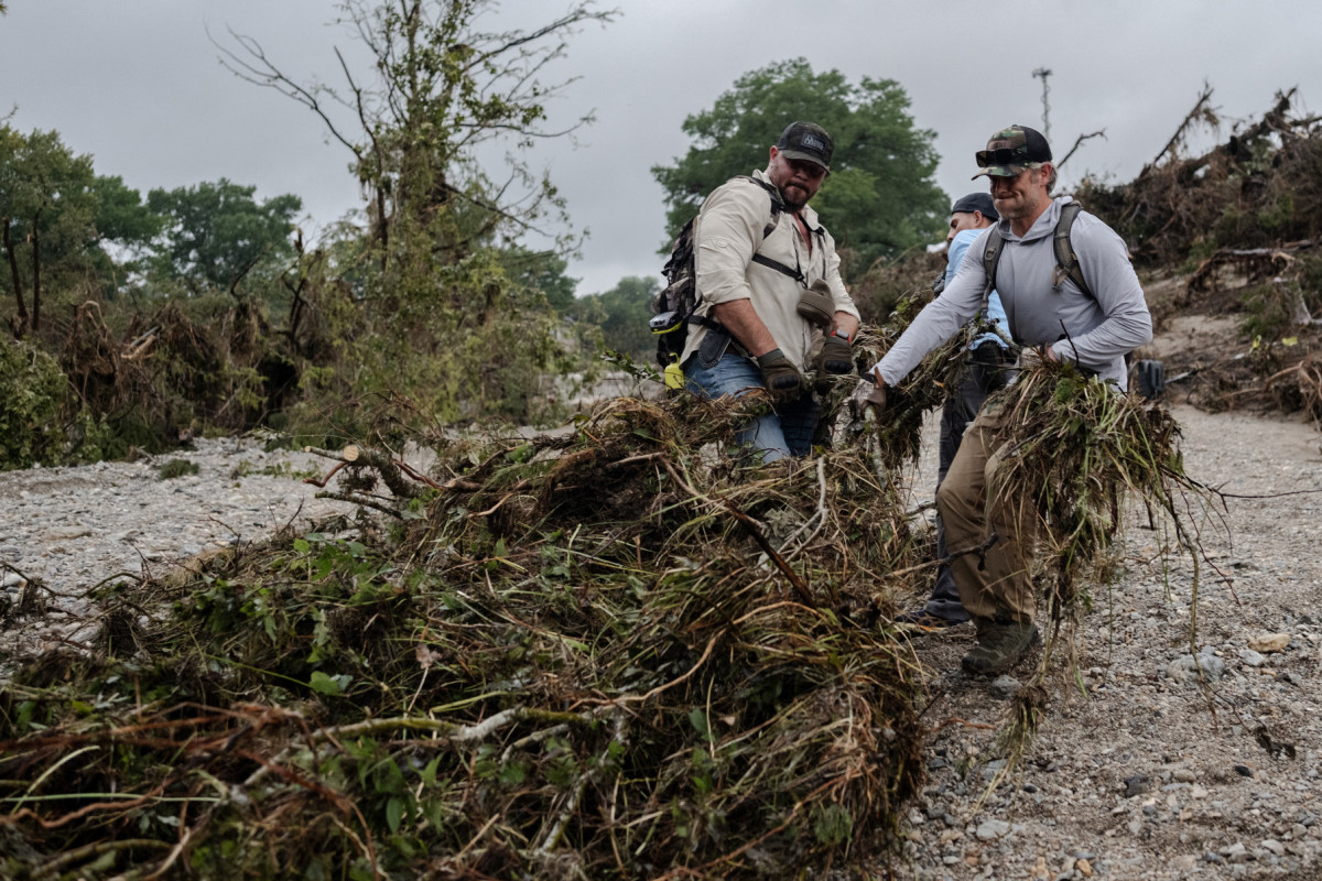 HUNT, TEXAS - JULY 6: Search and recovery workers dig through debris looking for any survivors or remains of people swept up in the flash flooding near Camp Mystic on July 6, 2025 in Hunt, Texas. Heavy rainfall caused flooding along the Guadalupe River in central Texas with multiple fatalities reported. ( Jim Vondruska / GETTY IMAGES NORTH AMERICA / Getty Images via AFP) HUNT, TEXAS - JULY 6: Search and recovery workers dig through debris looking for any survivors or remains of people swept up in the flash flooding near Camp Mystic on July 6, 2025 in Hunt, Texas. Heavy rainfall caused flooding along the Guadalupe River in central Texas with multiple fatalities reported./ Jim Vondruska / GETTY IMAGES NORTH AMERICA / Getty Images via AFP