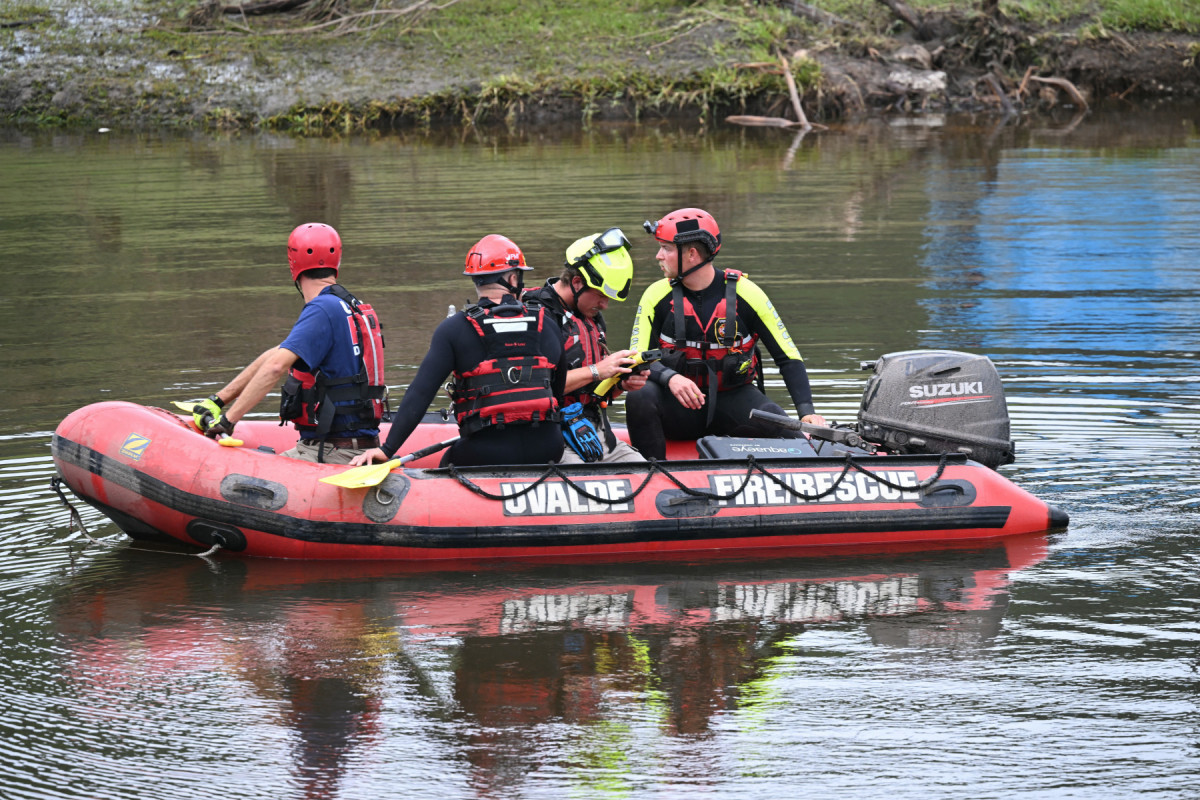  A search and rescue team looks for people along the Guadalupe River near a damaged building at Camp Mystic in Hunt, Texas, on July 7, 2025, following severe flash flooding that occurred during the July 4 holiday weekend. Rescuers in Texas continue to race against time to find dozens of missing people, including children, swept away by flash floods that killed more than 80 people, with forecasters warning of new deluges. In a terrifying display of nature's power, the rain-swollen waters of the Guadalupe River reached treetops and the roofs of cabins in Camp Mystic as girls slept overnight on Friday, July 4, washing away some of them and leaving a scene of devastation. 