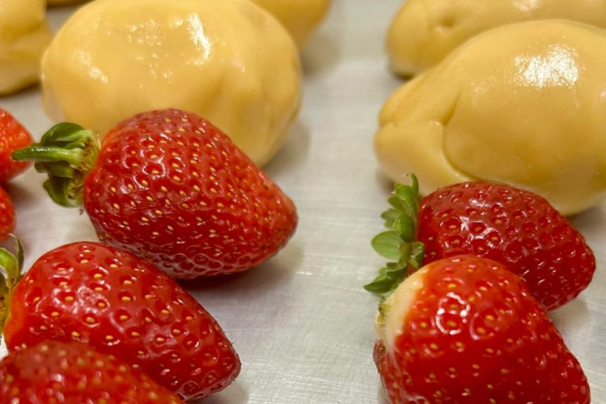 O doce é formado por um morango envolto por uma camada de brigadeiro branco e, por cima, uma cobertura de açúcar caramelizado.