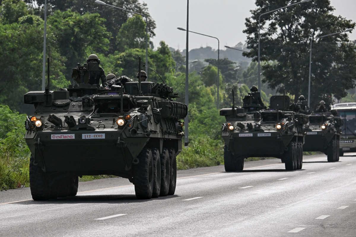  Royal Thai Army soldiers are pictured on armoured vehicles on a road in Chachoengsao province on July 24, 2025. Thailand launched air strikes on Cambodian military targets on July 24 as Cambodia fired rockets and artillery, killing at least 11 civilians, in a dramatic escalation of a long-running border row between the two neighbours. (Photo by Lillian SUWANRUMPHA / AFP)/ AFP