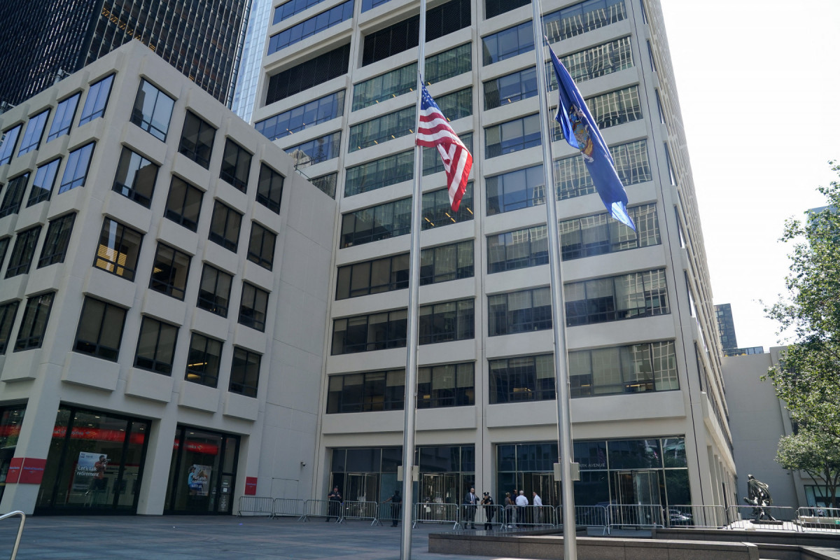  Flags fly at half-staff outside the 345 Park Avenue building, the scene of last night's deadly shootings in Midtown Manhattan in New York on July 29, 2025. A man who killed four people, then committed suicide in a New York skyscraper, may have been targeting the NFL offices there because he blamed the American football league for brain injuries he said he suffered, Mayor Eric Adams said Tuesday. The revelation that the killer, identified as 27-year-old Shane Tamura, carried a note referring to the degenerative brain disease chronic traumatic encephalopathy (CTE), offered the first possible motive for the shootings late Monday that brought central Manhattan to a standstill. 