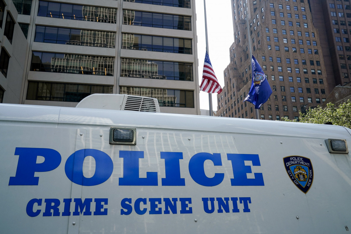 Flags fly at half-staff as a New York City Police Department (NYPD) vehicle is seen outside the 345 Park Avenue building, the scene of last night's deadly shootings in Midtown Manhattan in New York on July 29, 2025. A man who killed four people, then committed suicide in a New York skyscraper, may have been targeting the NFL offices there because he blamed the American football league for brain injuries he said he suffered, Mayor Eric Adams said Tuesday. The revelation that the killer, identified as 27-year-old Shane Tamura, carried a note referring to the degenerative brain disease chronic traumatic encephalopathy (CTE), offered the first possible motive for the shootings late Monday that brought central Manhattan to a standstill. (TIMOTHY A. CLARY / AFP) Flags fly at half-staff as a New York City Police Department (NYPD) vehicle is seen outside the 345 Park Avenue building, the scene of last night's deadly shootings in Midtown Manhattan in New York on July 29, 2025. A man who killed four people, then committed suicide in a New York skyscraper, may have been targeting the NFL offices there because he blamed the American football league for brain injuries he said he suffered, Mayor Eric Adams said Tuesday. The revelation that the killer, identified as 27-year-old Shane Tamura, carried a note referring to the degenerative brain disease chronic traumatic encephalopathy (CTE), offered the first possible motive for the shootings late Monday that brought central Manhattan to a standstill. /TIMOTHY A. CLARY / AFP