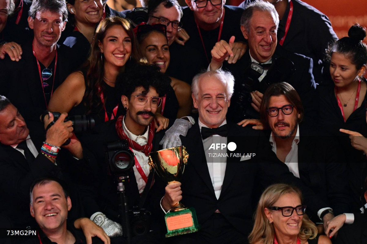 Ator italiano Toni Servillo posa com fotógrafos e a Coppa Volpi de Melhor Ator que recebeu por sua atuação em Ator italiano Toni Servillo posa com fotógrafos e a Coppa Volpi de Melhor Ator que recebeu por sua atuação em
