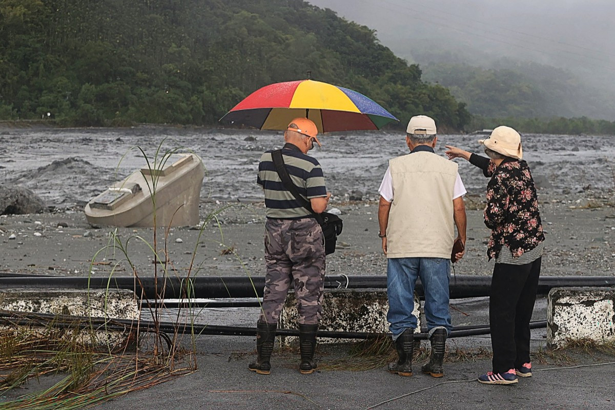 Pessoas observam os destroços deixados para trás após o rompimento de um lago de barreira, que causou a destruição de partes da ponte sobre o Riacho Mataian, em Hualien, em 24 de setembro de 2025. O rompimento do lago de barreira em Taiwan matou pelo menos 14 pessoas, disseram autoridades regionais em 24 de setembro, depois que o supertufão Ragasa atingiu a ilha com chuvas torrenciais. (Foto: Agência Central de Notícias de Taiwan (CNA) / AFP)
 ( AFP)