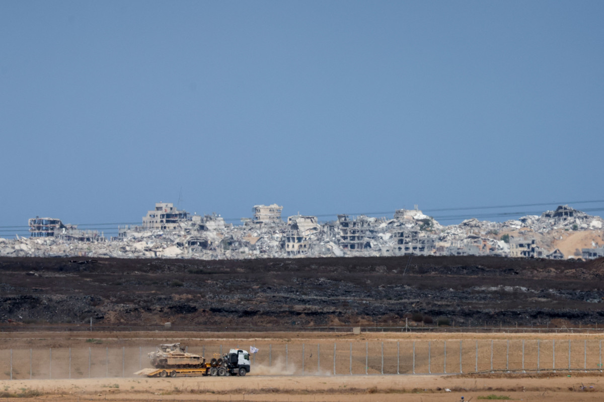 Um veículo blindado militar israelense é transportado na caçamba de um caminhão ao longo da fronteira entre Israel e Gaza, em 9 de outubro de 2025. Israel e o Hamas concordaram, em 9 de outubro, com um acordo de cessar-fogo em Gaza para libertar os reféns restantes, em um passo importante para encerrar uma guerra que matou dezenas de milhares de pessoas e desencadeou uma catástrofe humanitária. (Foto de Ahmad GHARABLI / AFP) ( AFP) Um veículo blindado militar israelense é transportado na caçamba de um caminhão ao longo da fronteira entre Israel e Gaza, em 9 de outubro de 2025. Israel e o Hamas concordaram, em 9 de outubro, com um acordo de cessar-fogo em Gaza para libertar os reféns restantes, em um passo importante para encerrar uma guerra que matou dezenas de milhares de pessoas e desencadeou uma catástrofe humanitária. (Foto de Ahmad GHARABLI / AFP)/ AFP