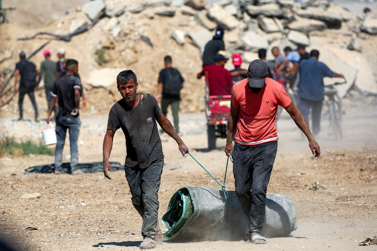  Palestinos a caminho da Cidade de Gaza (EYAD BABA / AFP)