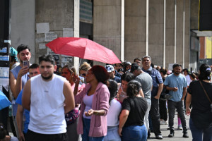 Pessoas fazem fila do lado de fora de um supermercado em Caracas