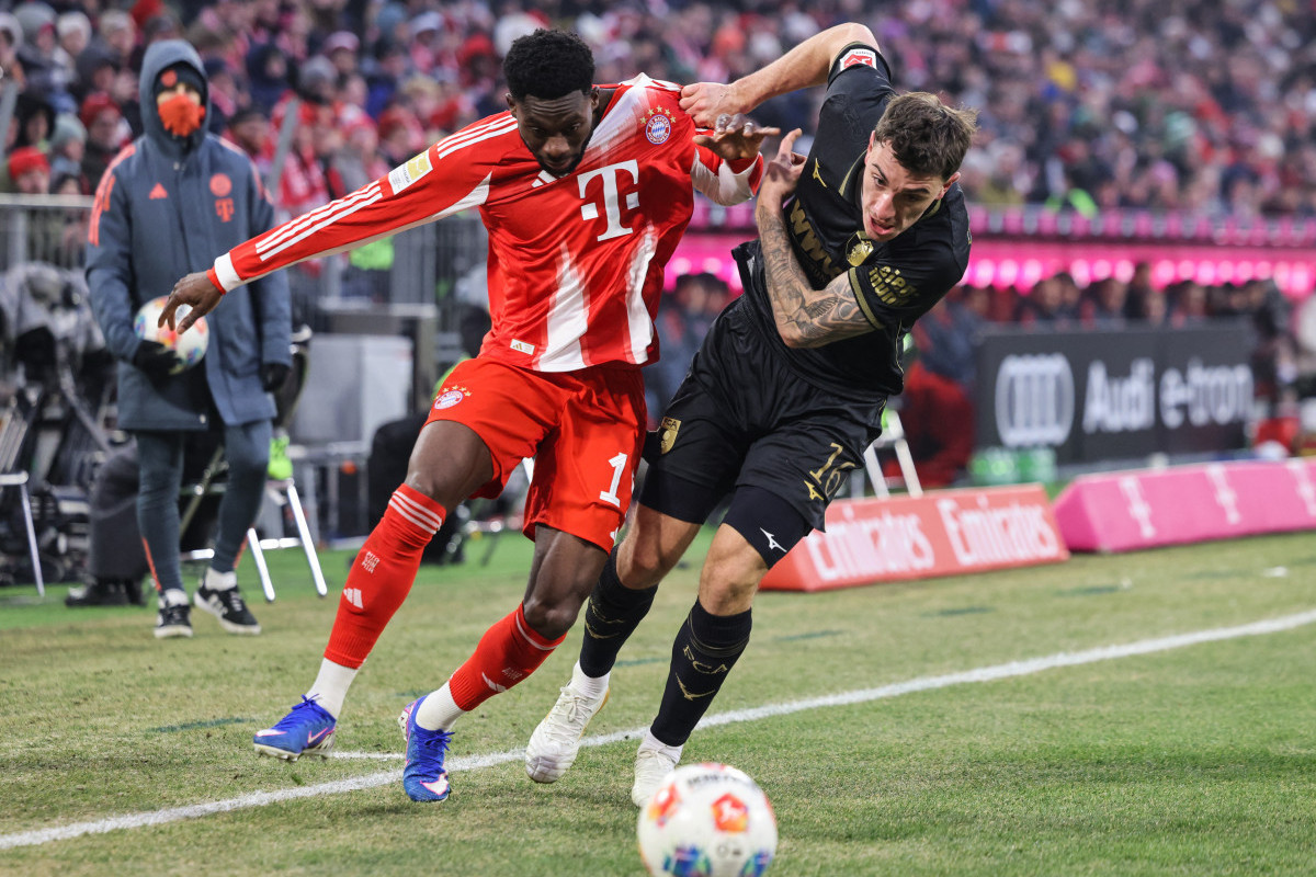Os laterais Alphonso Davies e Cedric Zesiger em disputa no jogo Bayern x Augsburg, válido pela Bundesliga/ALEXANDRA BEIER / AFP