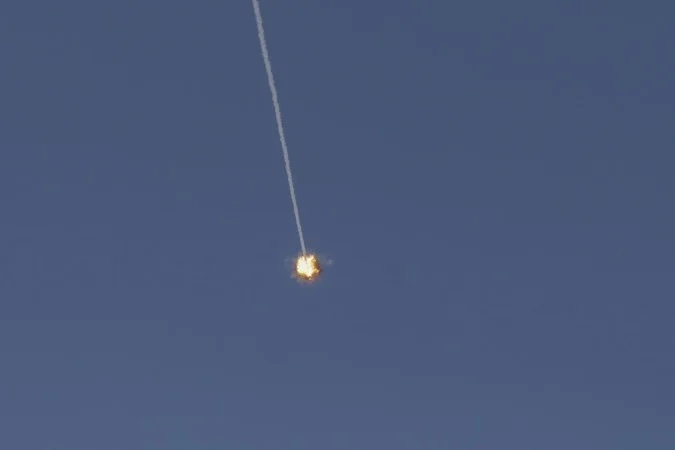 Esta imagem, tirada de um ponto na região da Alta Galileia, no norte de Israel, mostra um míssil Domo de Ferro israelense cruzando o céu para interceptar projéteis em 8 de junho de 2026/JALAA MAREY / AFP
