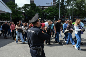 Um membro da Secretaria de Seguran&ccedil;a Cidad&atilde; usa um megafone para dar instru&ccedil;&otilde;es a pessoas evacuadas de v&aacute;rios pr&eacute;dios, ap&oacute;s uma evacua&ccedil;&atilde;o preventiva na Cidade do M&eacute;xico