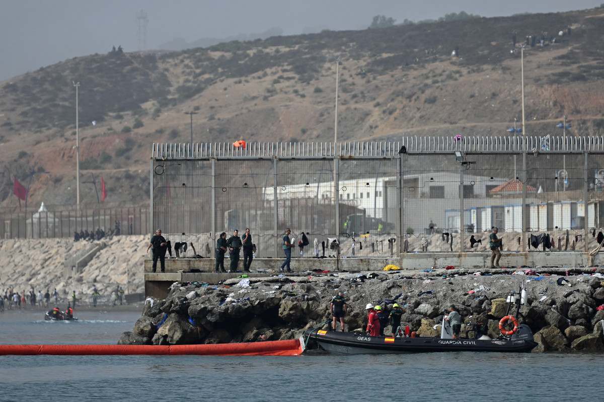 Uma barreira pneumática de 500 metros de extensão é lançada na água por uma embarcação da Guarda Civil espanhola, perto do posto de fronteira, para reforçar a segurança após travessias ilegais do Marrocos para o enclave espanhol de Ceuta/JORGE GUERRERO/AFP