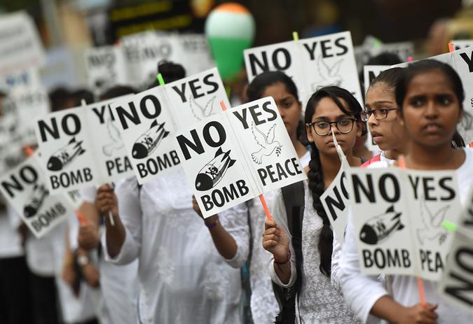 Estudantes indianos seguram cartazes com slogans pela paz durante um comcio para celebrar o Dia de Hiroshima, em Mumbai. Foto: PUNIT PARANJPE / AFP