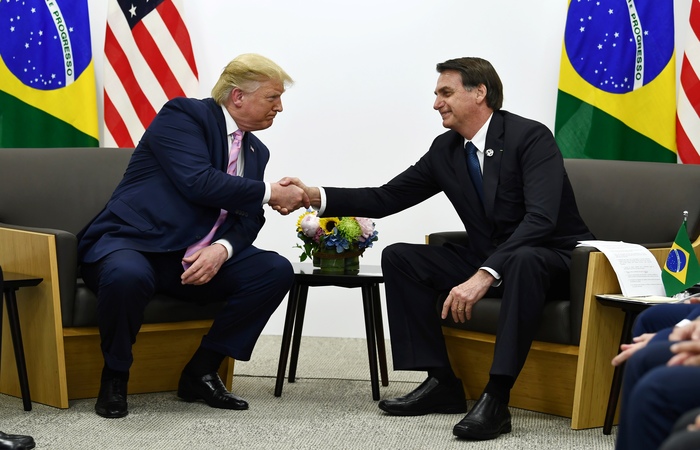 Bolsonaro disse que uma visita de Trump ao Brasil seria 'motivo de orgulho' para o pas. Foto: Brendan Smialowski / AFP