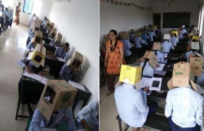 Alunos usam caixas de papelo na cabea durante prova na ndia. Foto: Reproduo/Twitter