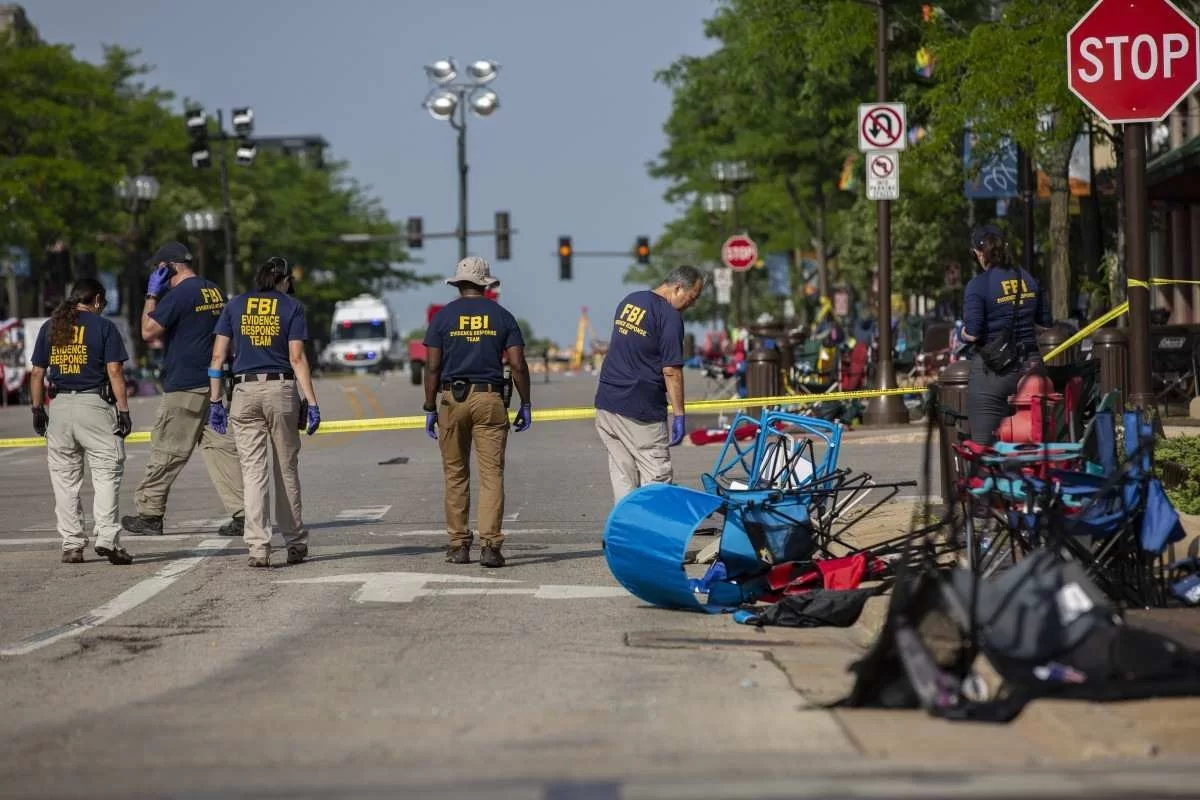 Agentes do FBI buscam provas no local do tiroteio em massa, na avenida onde ocorria a parada cívica do Dia da Independência, a 43km de Chicago. (Foto: Jim Vondruska/Getty Images/AFP)