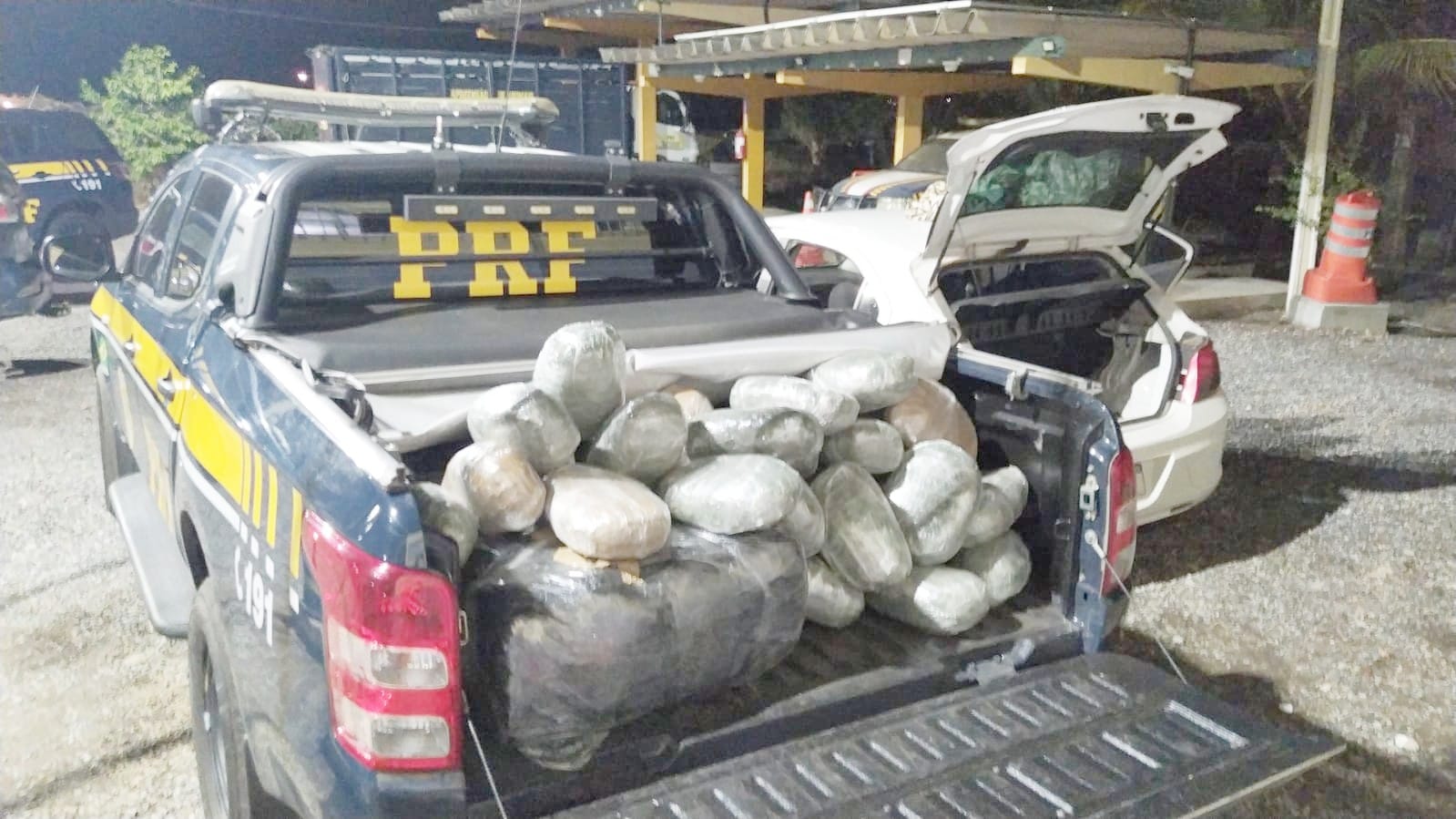 Um casal e um bebê de 4 meses, transportado no colo da mãe no banco da frente. Estavam no carro havia diversos tabletes da droga, dentro do porta-malas e no banco de trás, havendo apenas espaço para o bebê-conforto (Foto: Divulgação/PRF)