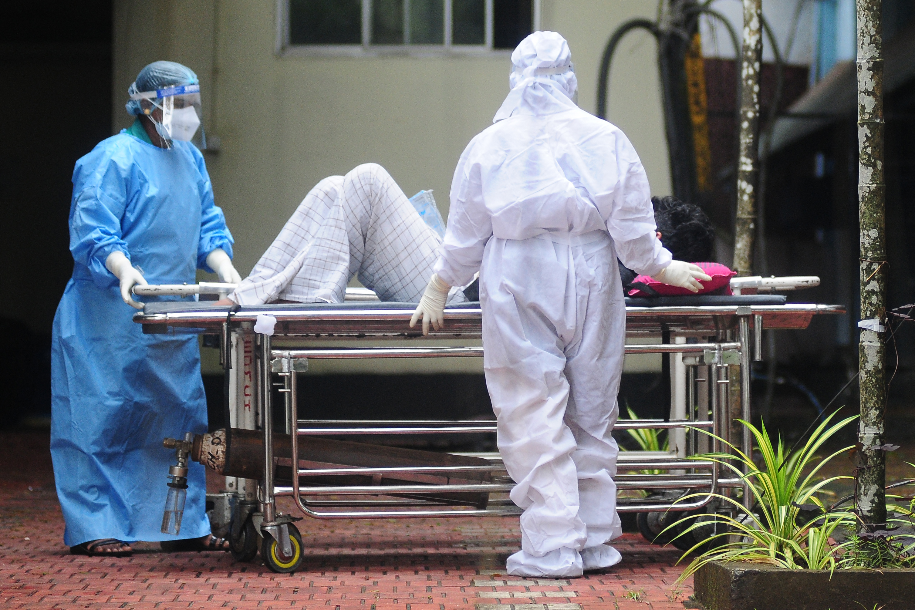 Agentes de Sade usam trajes de proteo no transporte de um homem com sintomas do vrus Nipah no sul da ndia. (AFP)